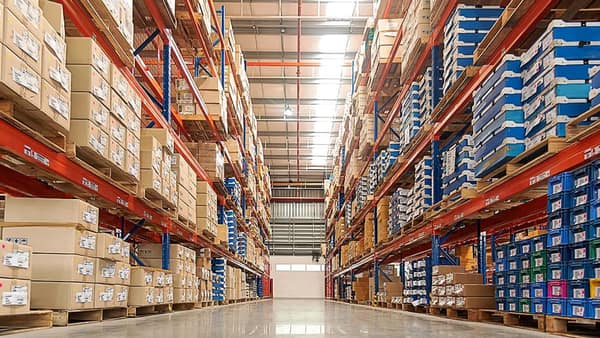 Warehouse aisles with tall racks of stored cartons