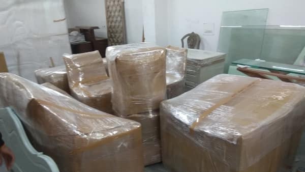 Wrapped furniture and a glass table top prepared for transport