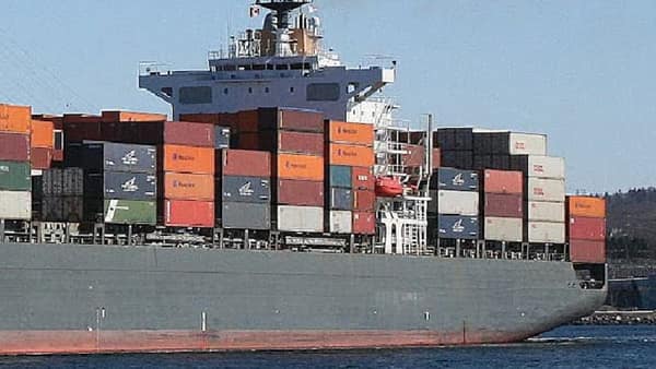 Container ship loaded with cargo at sea