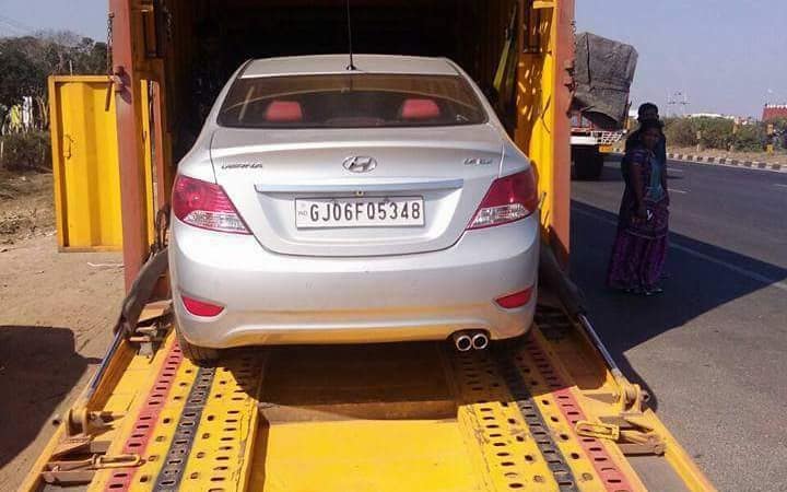 Sedan loaded on the deck of a car carrier truck